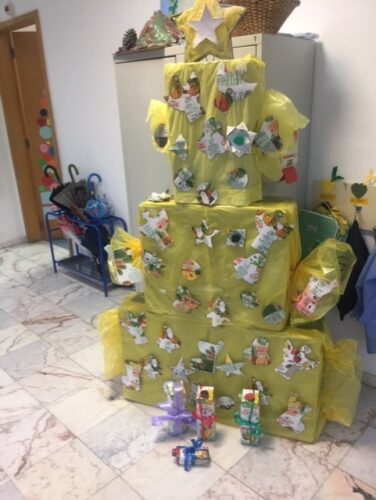 Árvore de Natal amarela construída com materiais reciclados.